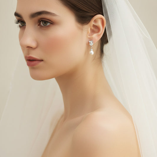 Pearl earring worn on an ear with a blurred background