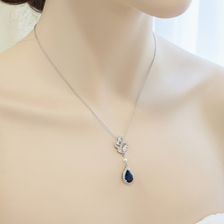Blue crystal bridal earrings with halo setting shown on a model