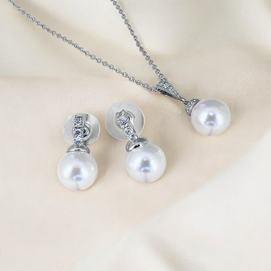 White pearl crystal earrings and necklace styled as wedding jewelry for brides and formal occasions