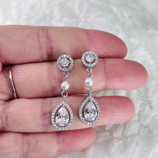 Clear crystal pearl earrings photographed to highlight sparkle and balanced proportions