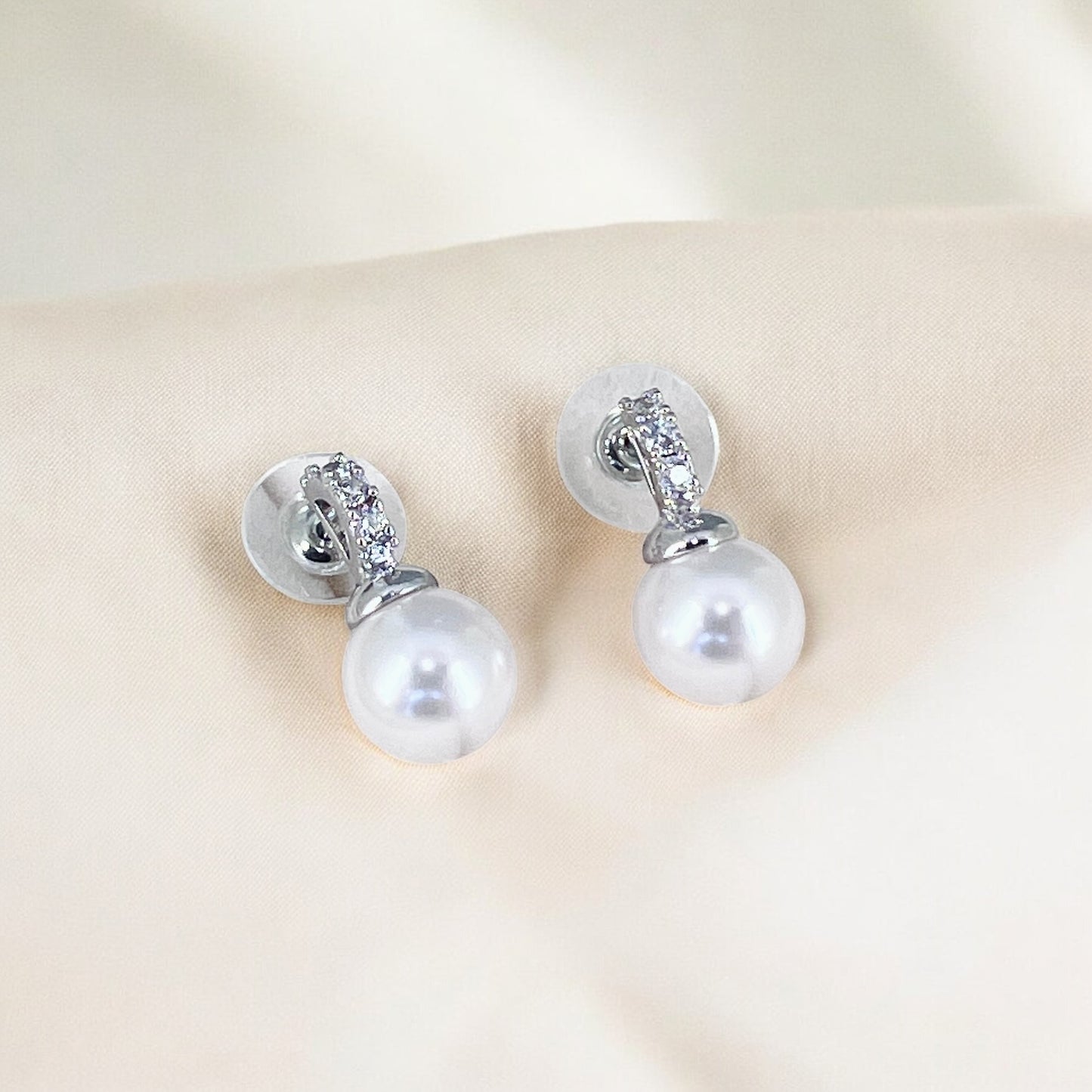 Bridal pearl earrings with crystal tops displayed to highlight craftsmanship and finish