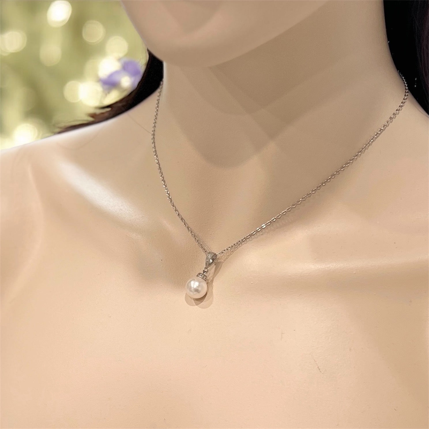 Pearl necklace on a mannequin with a blurred background