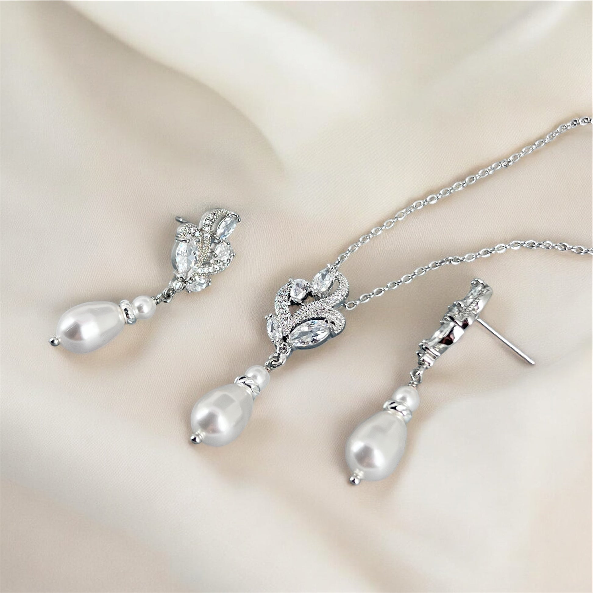 Floral marquise jewelry set with pearls on a soft beige background