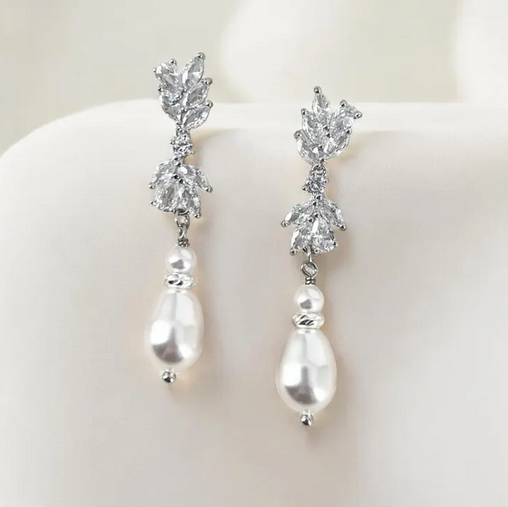 Pearl and CZ floral drop earrings on a white background