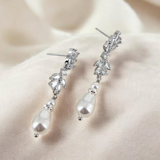 Silver CZ floral marquise with pearl earrings on a soft color background