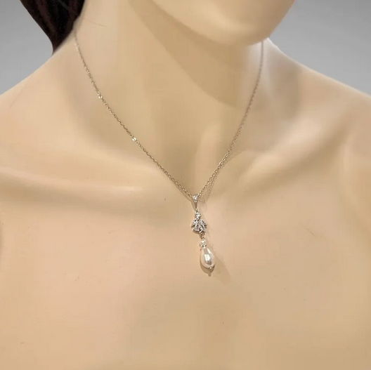 Necklace with a CZ floral white pearl pendant on a mannequin