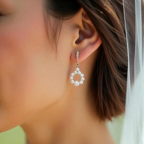 Close-up of a bride with veil wearing a delicate earring outdoor