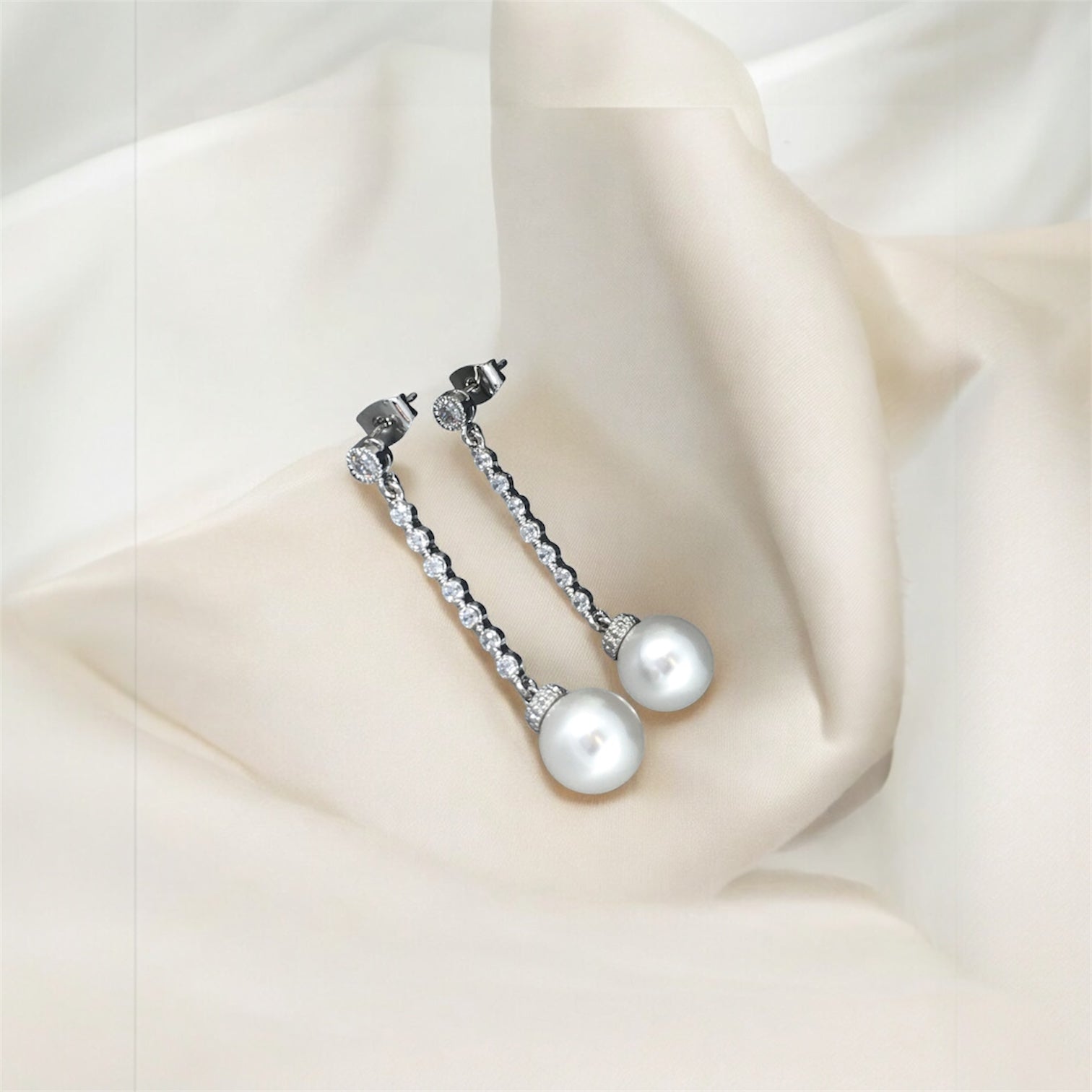 Bridal pearl and crystal earrings showing sparkle and luminous pearl drops for luxury wedding accessory