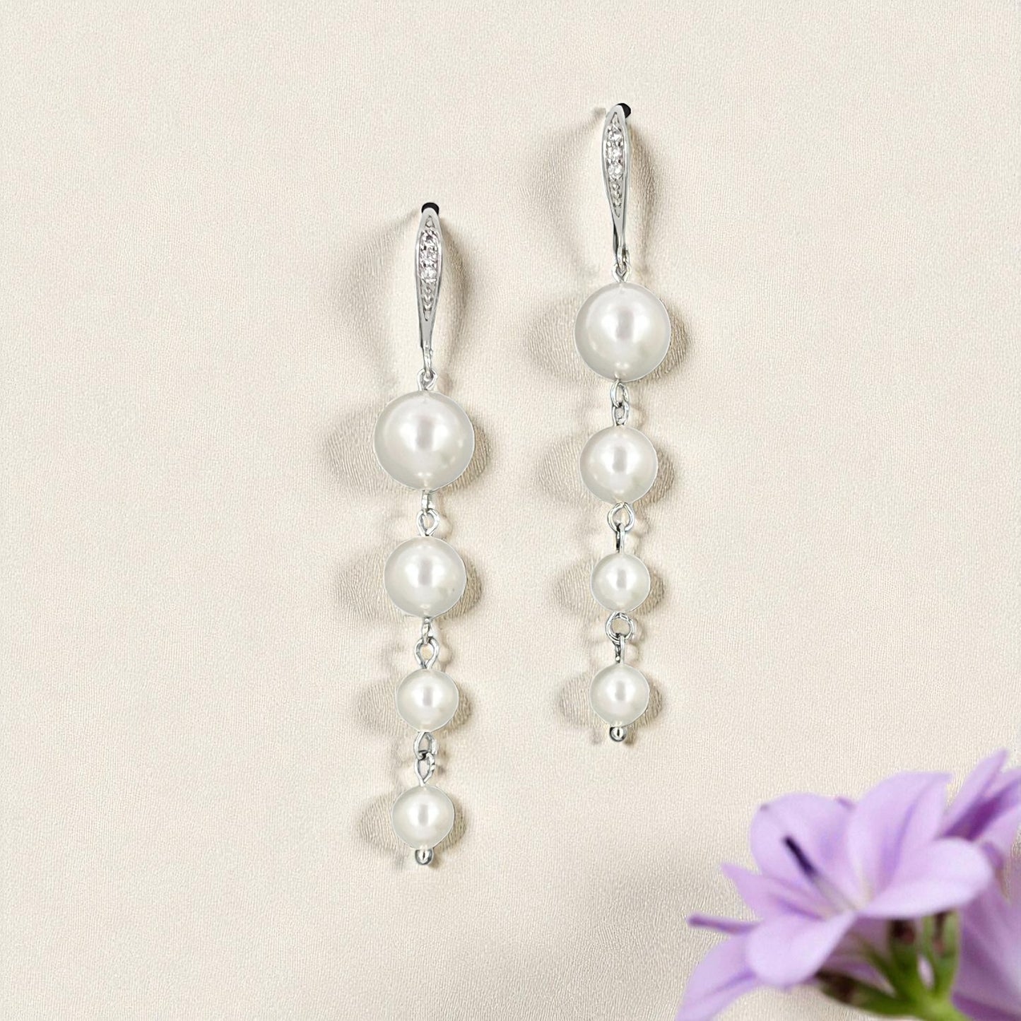 Long pearl drop earrings with cascading white pearls on silver earrings wire