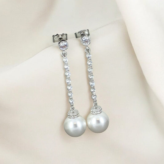 Sparkling crystal chain pearl earrings photographed in natural light to highlight movement, shine, and refined craftsmanship